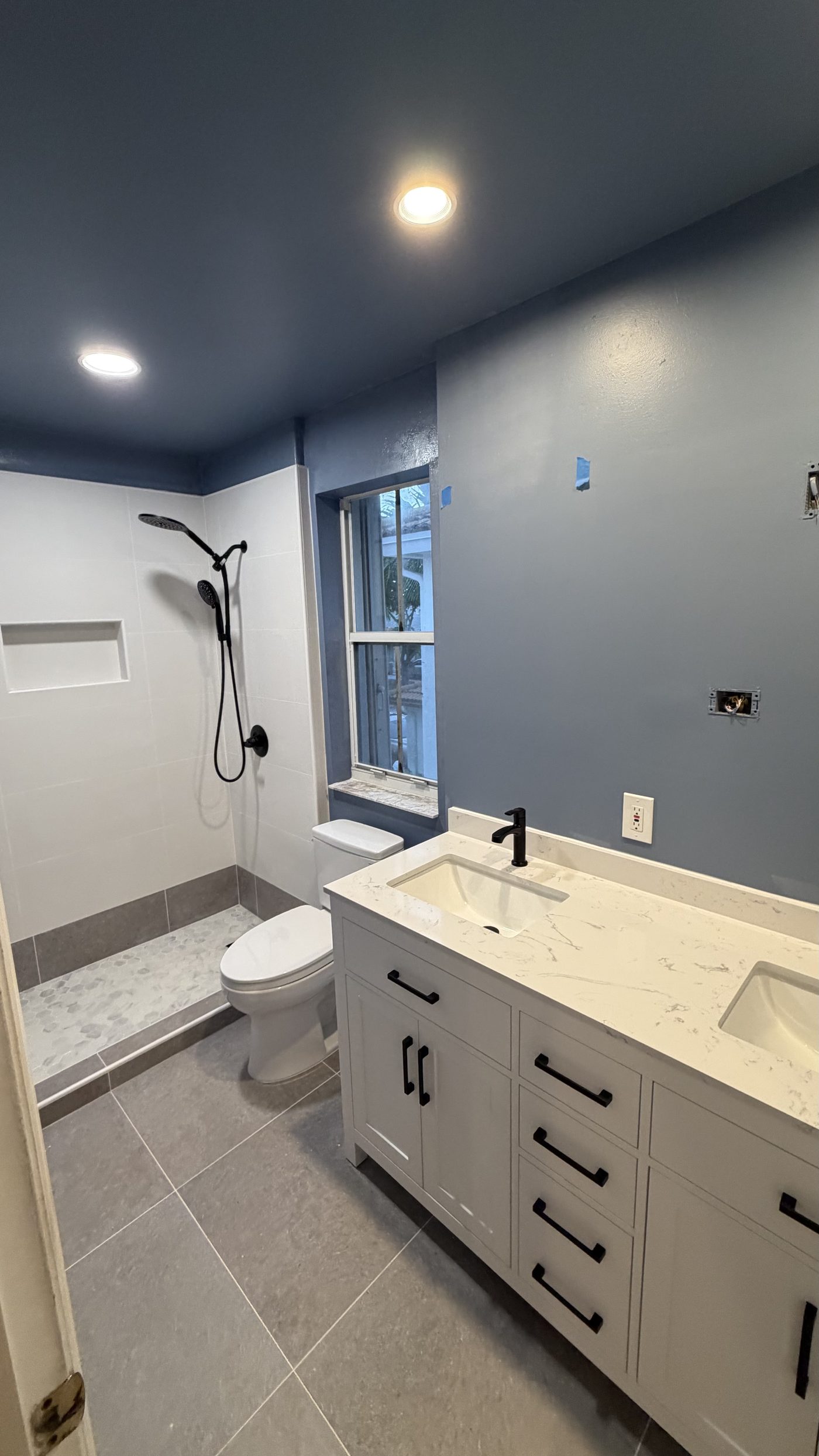 Remodeled bathroom with walk-in shower and double vanity